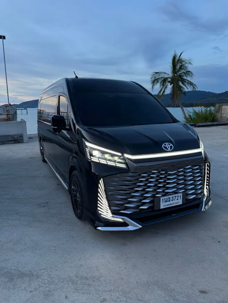 The villa’s black VIP van parked on the forecourt with palms behind.