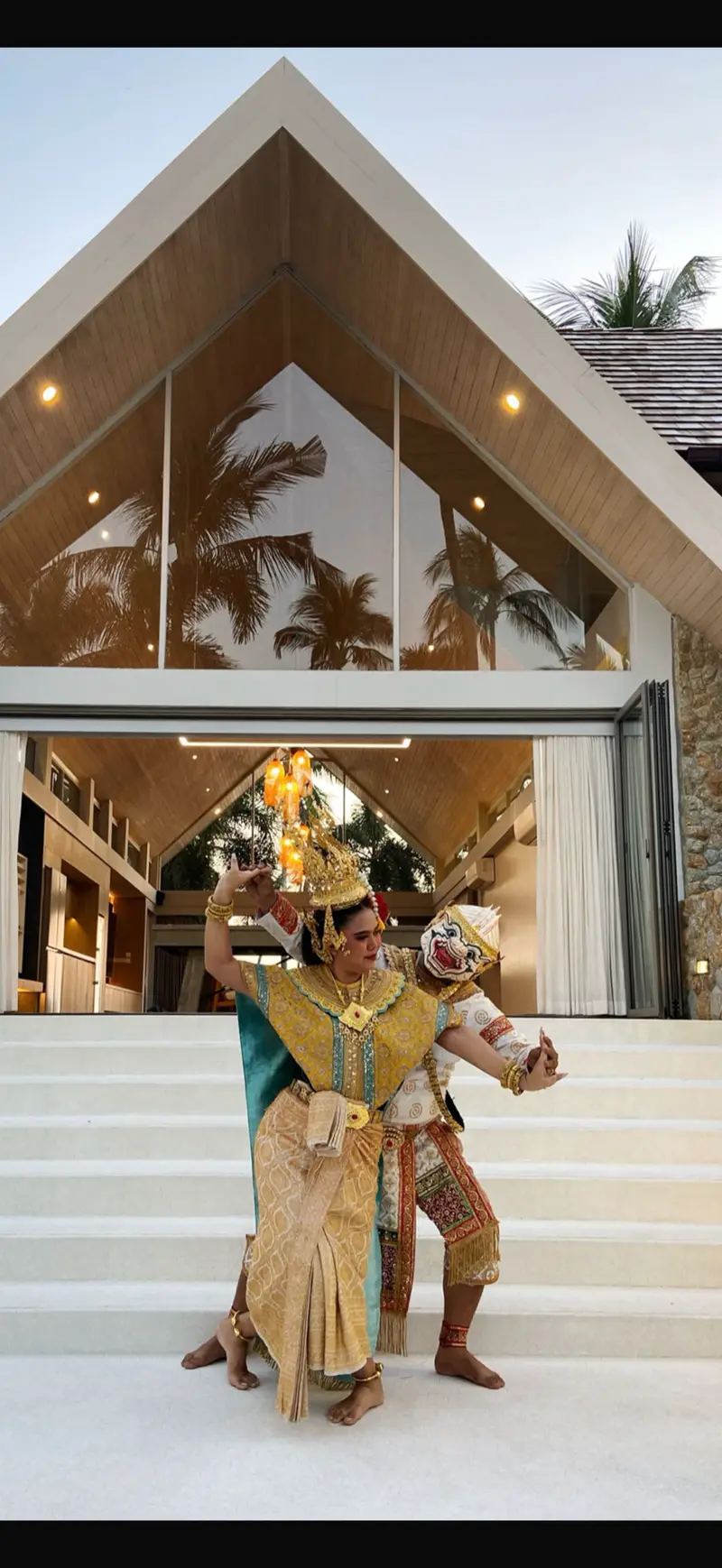 A dancer in traditional Thai costume performing at the villa.