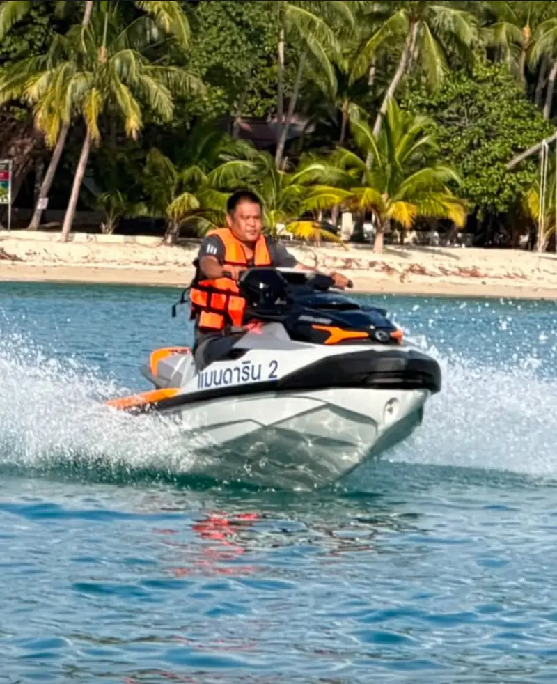 One of Mandarin Beach Villa’s two Sea-Doo jet skis, named Mandarin 2 in Thai, under way off the beach with its rider in a life jacket.