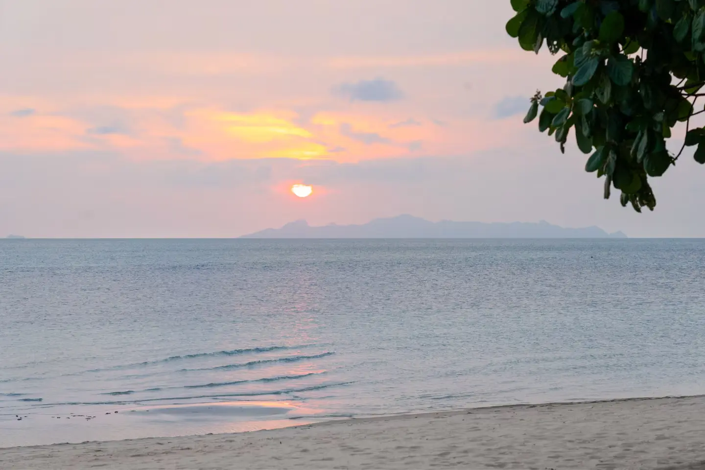 Spectacular tropical sunset across beachfront gardens at Mandarin Beach Villa Koh Samui.
