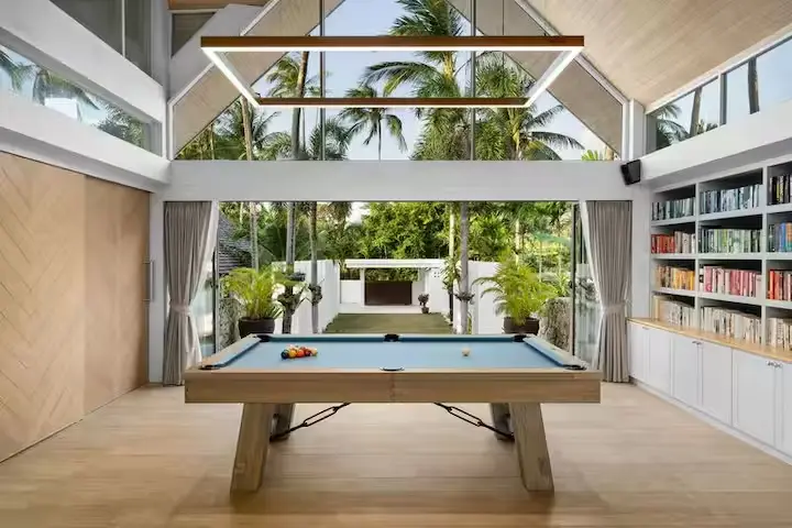 Luxury family games lounge with custom pool table overlooking tropical gardens at Mandarin Beach Villa Koh Samui.