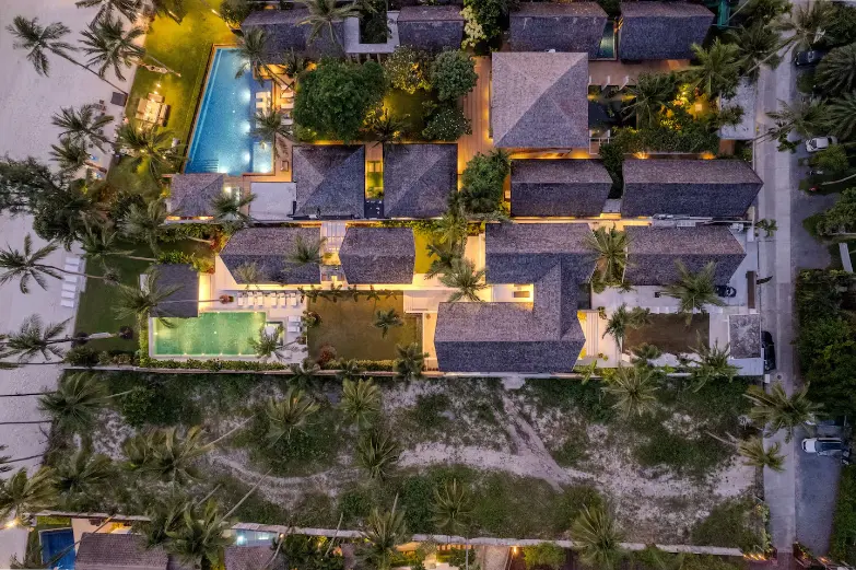 Luxury beachfront family estate illuminated at night in Koh Samui.