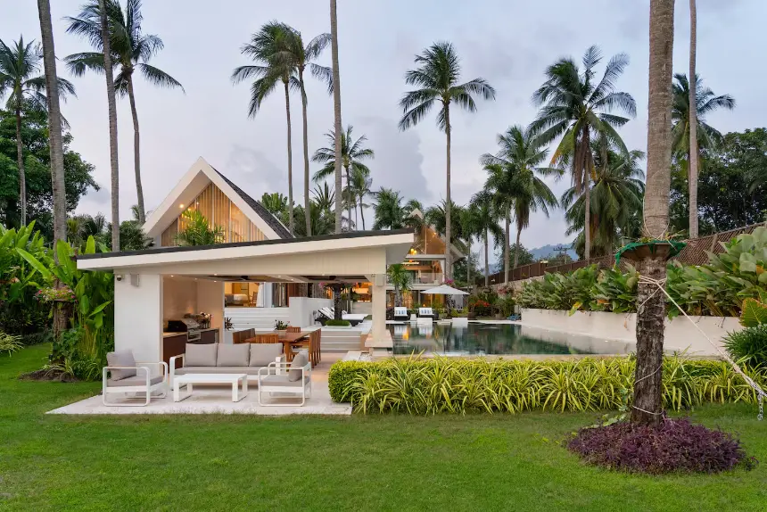 View from the beach towards Mandarin Beach Villa Koh Samui surrounded by tropical gardens.