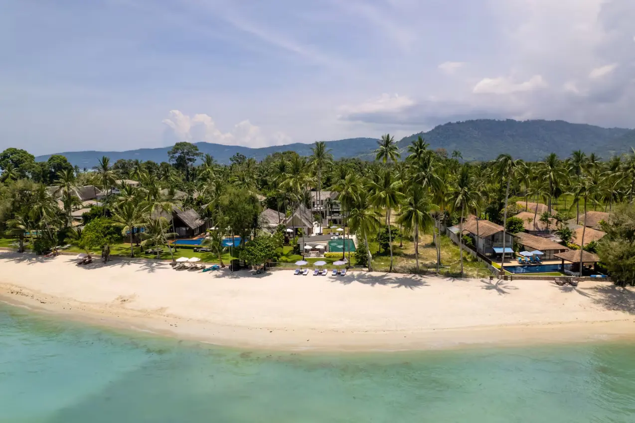 Drone view of white sand beachfront and tropical estate at Mandarin Beach Villa Koh Samui.